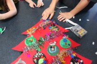 Place ornament around tinsel.