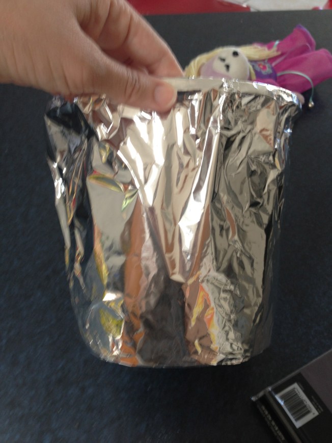 Covering the plastic pot with aluminium foil