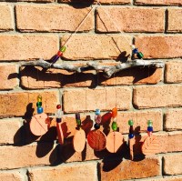 Beaded sun catcher with clay discs.